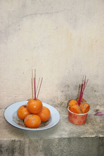 Incense sticks displayed in an orange for a wedding ritual